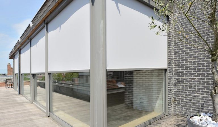 Covered shed with roller blinds